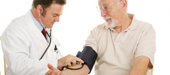 Doctor examining elderly male patient